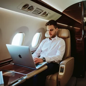 a high ticket client flying on a private jet considering a sales offer on his laptop
